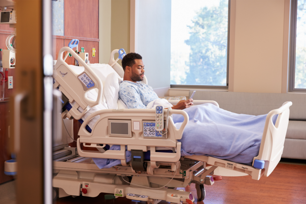 a man lying on the hospital bed