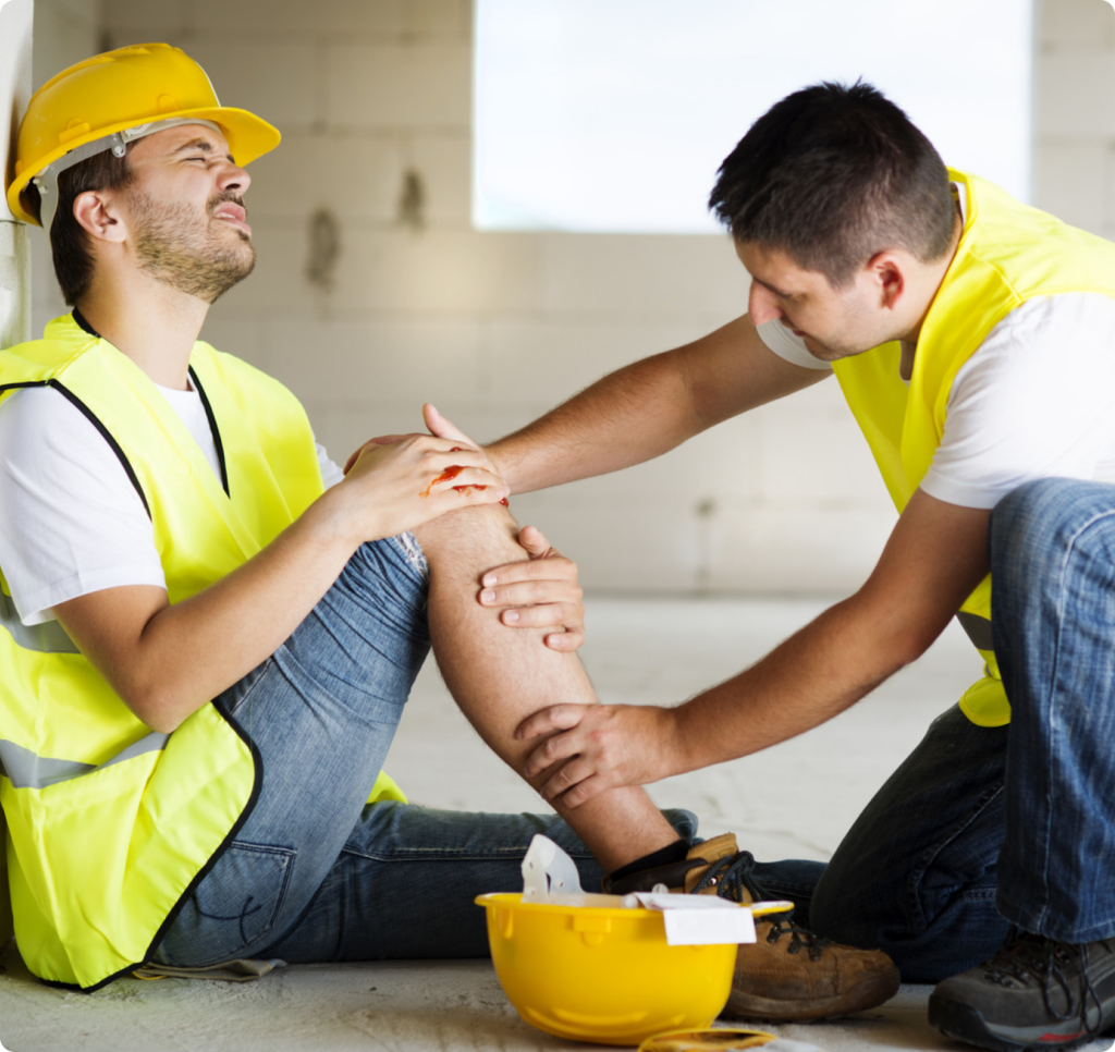 a worker helping another worker with knee injury