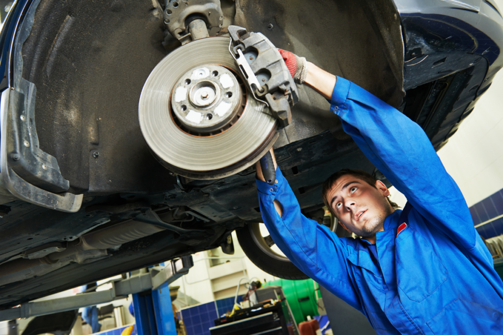 Auto mechanic working on brake shoe