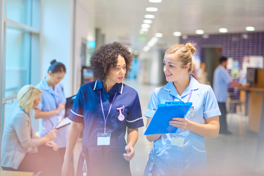 Nurses talking and looking at chart