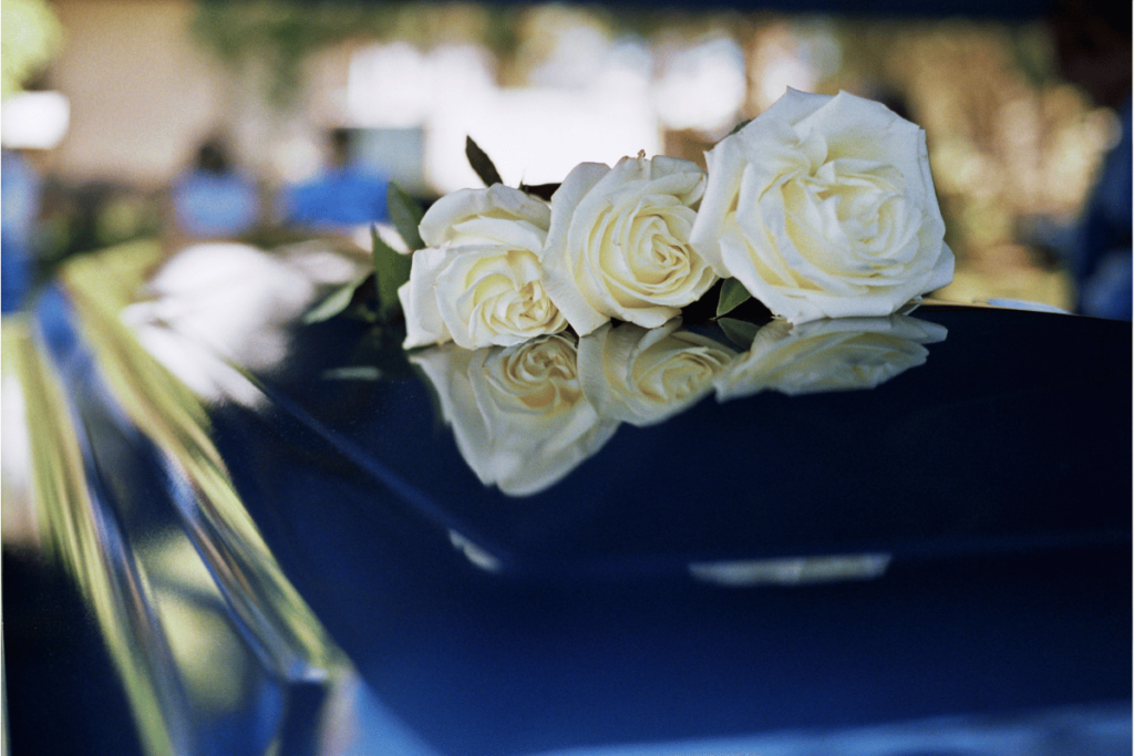 closeup of white flowers on a funeral coffin