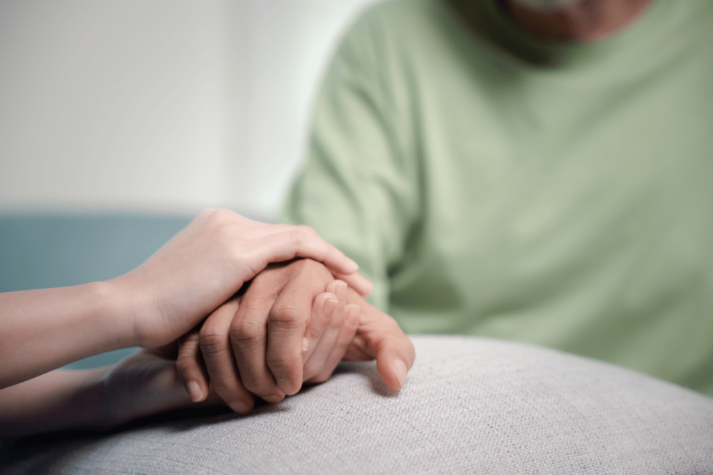 caretaker holding senior citizen's hand