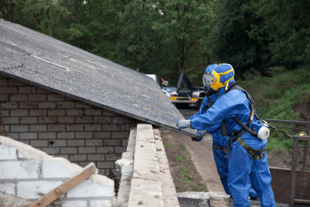 abatement workers removing asbestos roofing