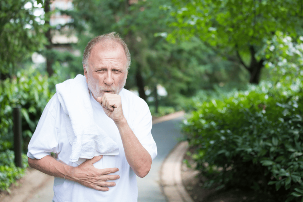 elderly man coughing while exercising