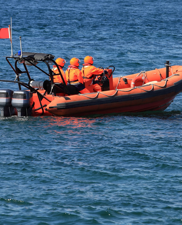 three people on a sea boat