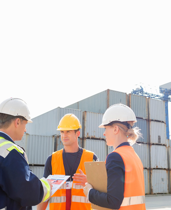 three workers at a ship yard