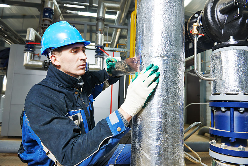 a man insulating factory machines