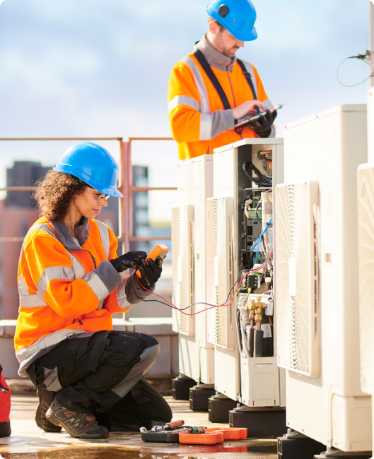 Two electricians working at the feeder pillar