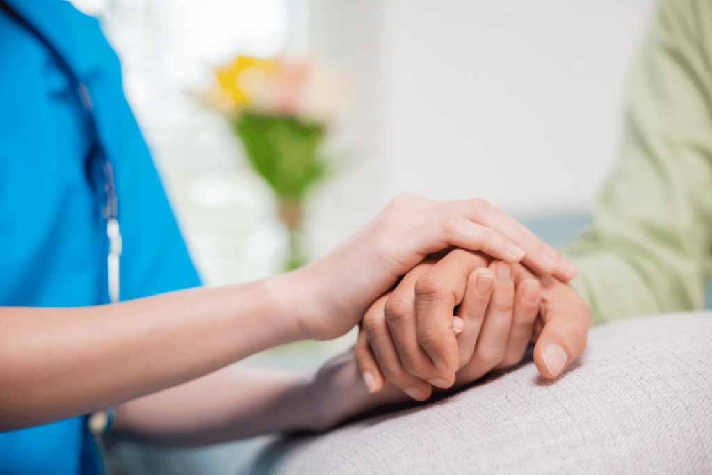 close up of doctor holding patients hand