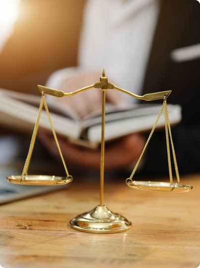 a magnified view of a man reading a book in front of the justice scale