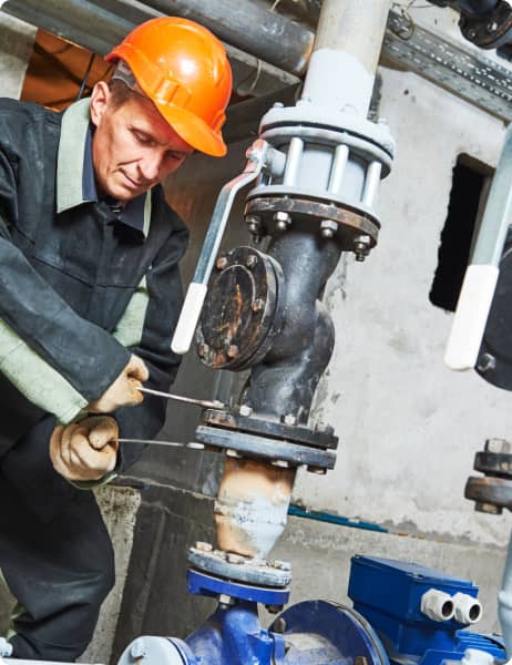 Maintenance worker bolting an heavy machine