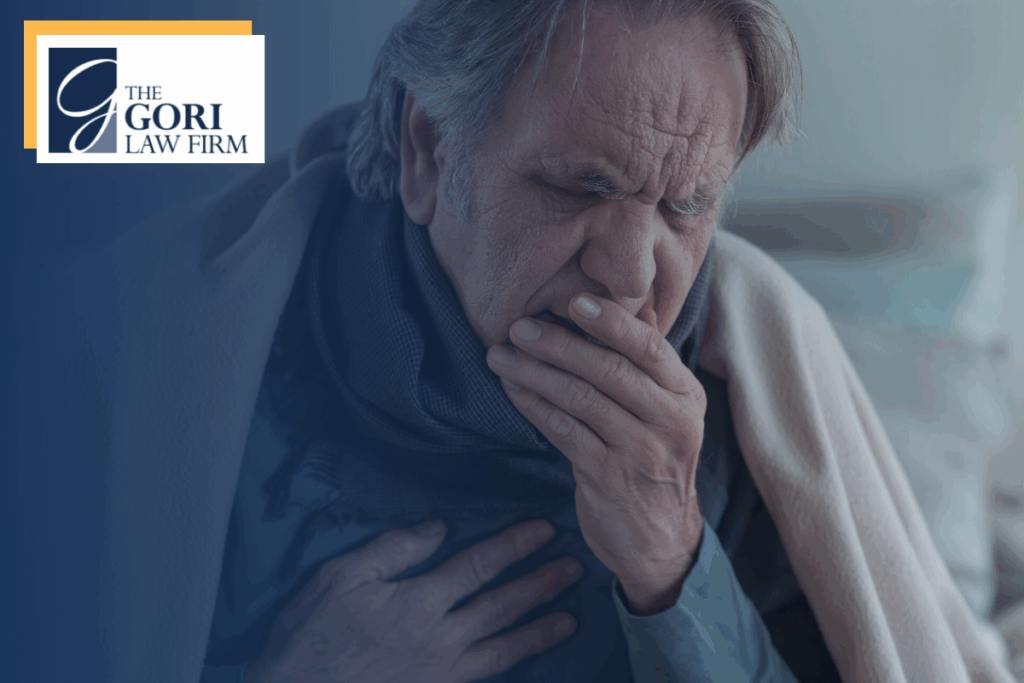 Man coughing into hand and holding chest.