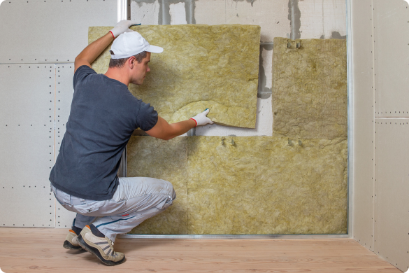 a worker placing an asbestos insulator on the wall